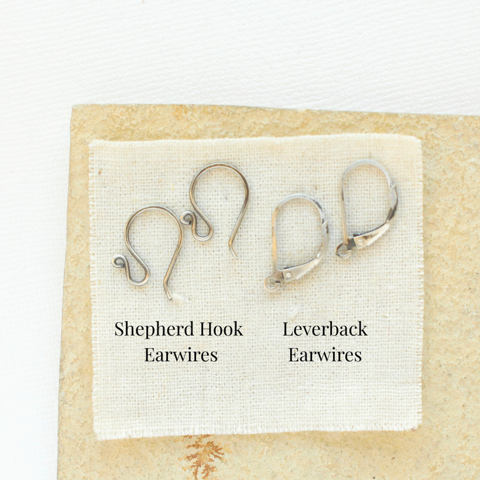 Oxidized silver shepherd hook earwires and leverback earwires styled on a tan rock to show the earwire options