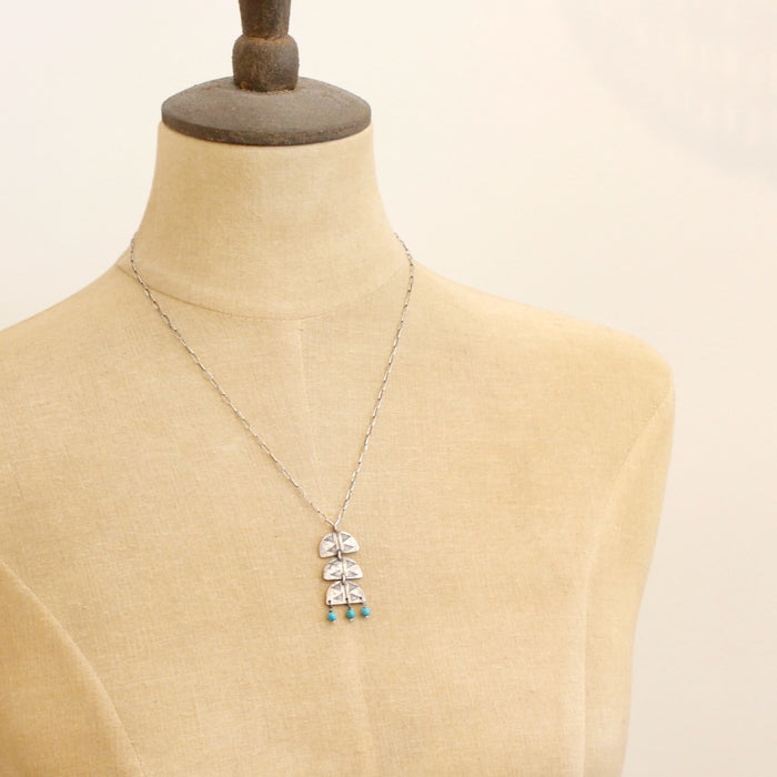 A mannequin wearing the pakal trio turquoise necklace 