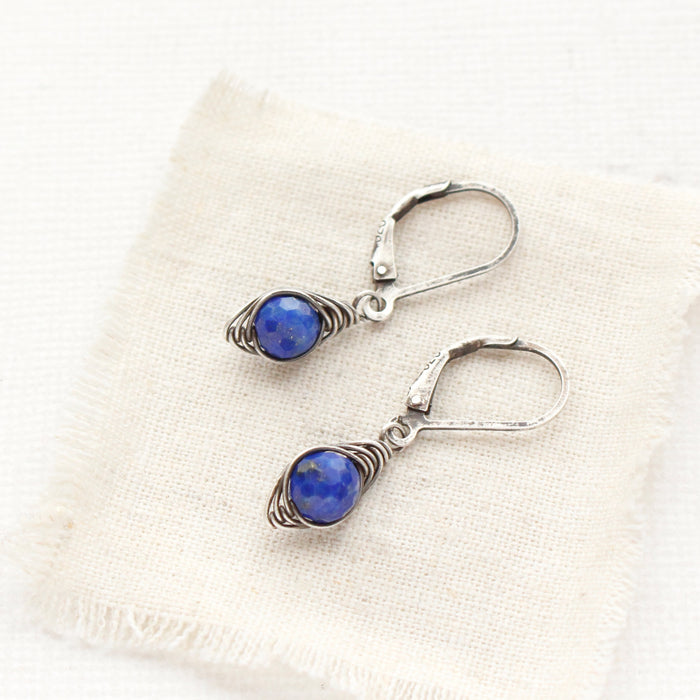 The perfect wrap lapis earrings styled on tan linen