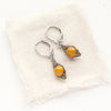 The perfect wrap mookaite earrings styled on tan linen