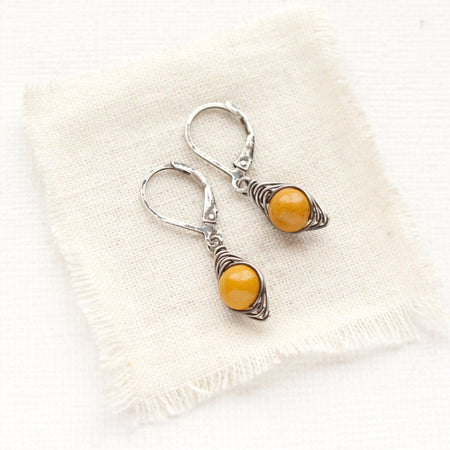 The perfect wrap mookaite earrings styled on tan linen