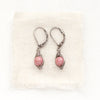 The perfect wrap rhodonite earrings styled on tan linen
