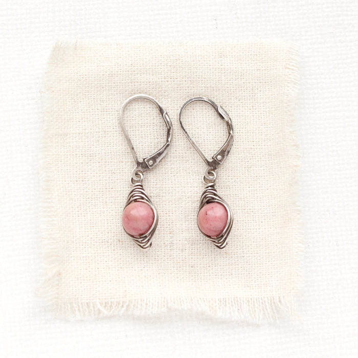 The perfect wrap rhodonite earrings styled on tan linen