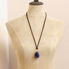 A mannequin wearing the pinned sodalite adjustable leather necklace to show the longer length option