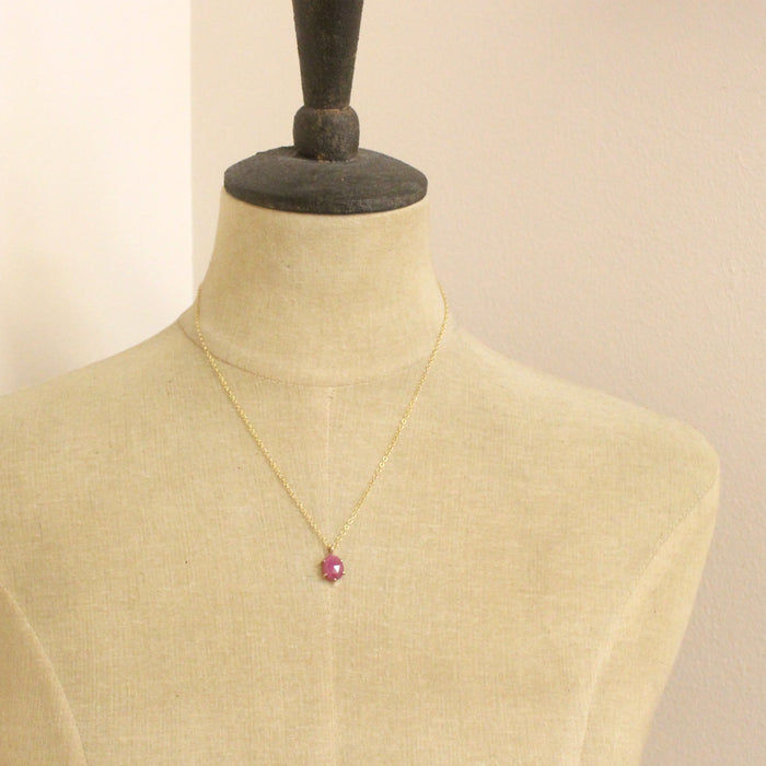 A mannequin wearing the prong set ruby necklace