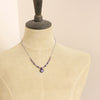 A mannequin wearing the purple rain necklace 