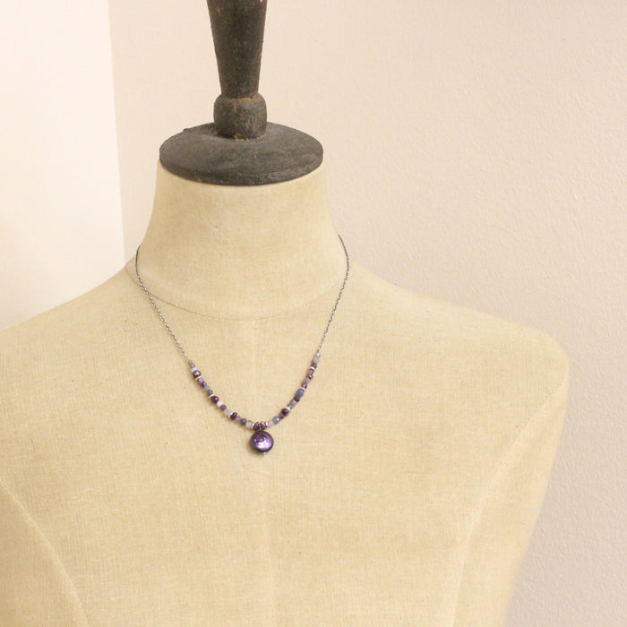 A mannequin wearing the purple rain necklace 