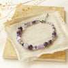 The purple rain gemstone bracelet styled on a tan rock