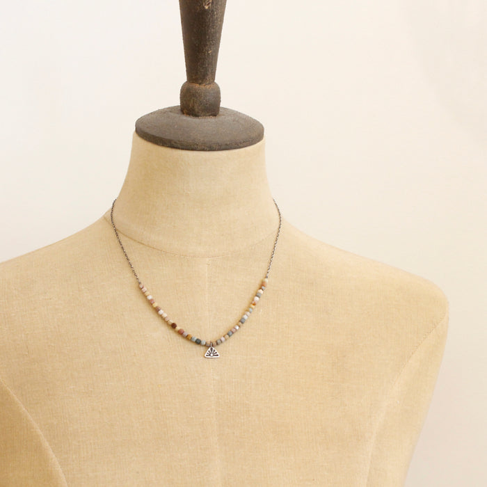 A mannequin wearing the rainbow agate sun rise charm necklace