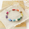 The rainbow bracelet styled on a tan rock with dried grass