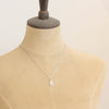 A mannequin wearing the rainbow moonstone silver bar necklace