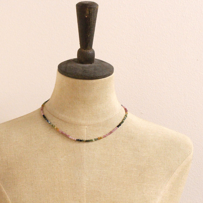 A mannequin wearing the rainbow tourmaline necklace