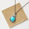The royston turquoise stamped arch necklace styled on brown leather