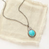 The royston turquoise stamped arch necklace styled on tan linen
