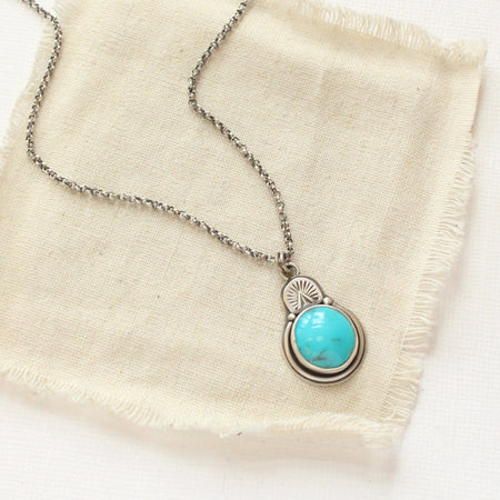 The royston turquoise stamped arch necklace styled on tan linen