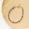 The sapphire cleo bracelet styled on a tan plate with dried grass