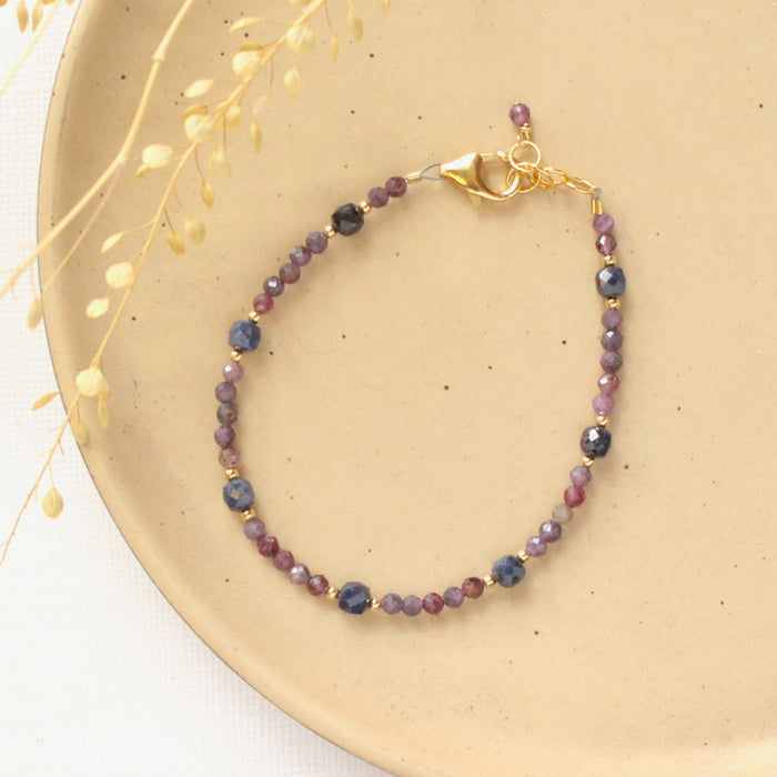 The sapphire cleo bracelet styled on a tan plate with dried grass