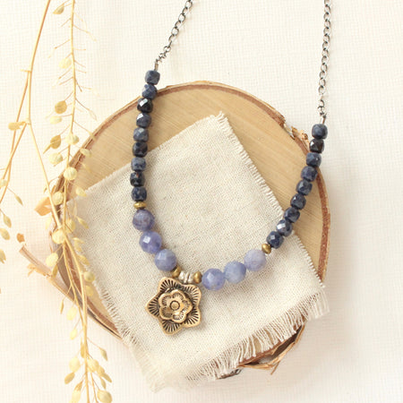 The bronze cactus flower vinca necklace styled on wood with linen and dried grass