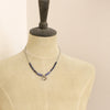A mannequin wearing the bronze cactus flower vinca necklace