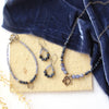 The vina cactus flower collection styled on a tan rock with blue velvet and dried grass