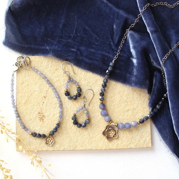 The vina cactus flower collection styled on a tan rock with blue velvet and dried grass