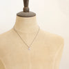 A mannequin wearing the small musana sun necklace