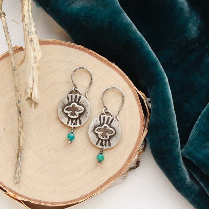 The layered soar amazonite earrings styled on wood with blue velvet and dried grass