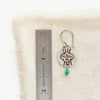 A layered soar amazonite earring next to a ruler for size reference