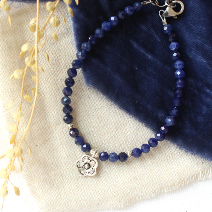 The mini cactus flower sodalite bracelet styled on tan linen with blue velvet and dried grass