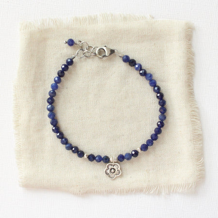 The mini cactus flower sodalite bracelet styled on tan linen