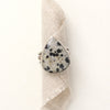 The southwest dalmatian jasper statement ring styled on rolled tan linen