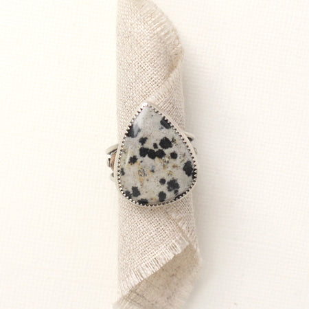 The southwest dalmatian jasper statement ring styled on rolled tan linen