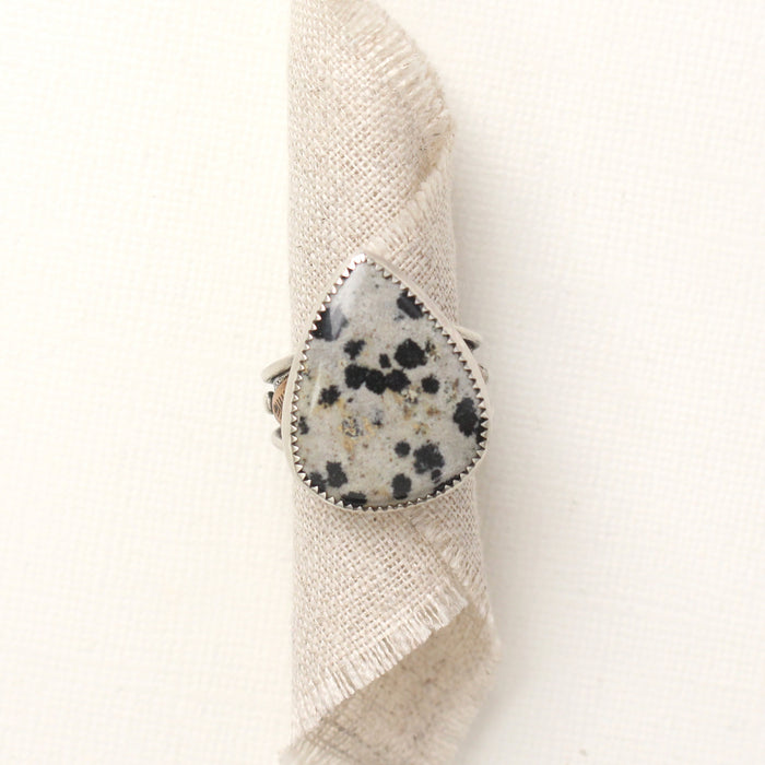 The southwest dalmatian jasper statement ring styled on rolled tan linen