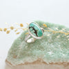 The southwest turquoise ring styled on a green crystal with dried grass