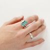 A hand wearing the southwest turquoise ring