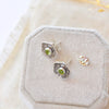 The stamped flower peridot post earrings styled to show the butterfly earbacks