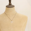 A mannequin wearing the asmi short loop necklace