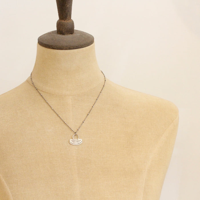 A mannequin wearing the asmi short loop necklace