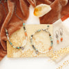 The talara sun mesa pieces styled on a tan rock with orange velvet and a crystal