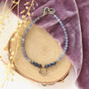 The bronze mini cactus flower vinca bracelet styled on wood with purple velvet and dried grass