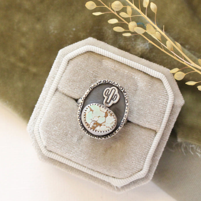 The little cactus turquoise ring styled on a velvet box with green velvet and dried grass