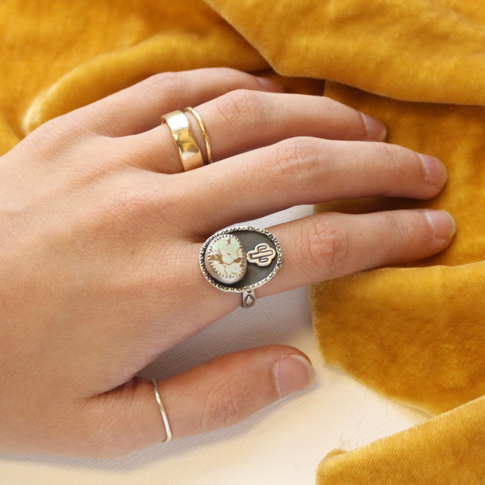 The little cactus turquoise ring bring worn on a hand
