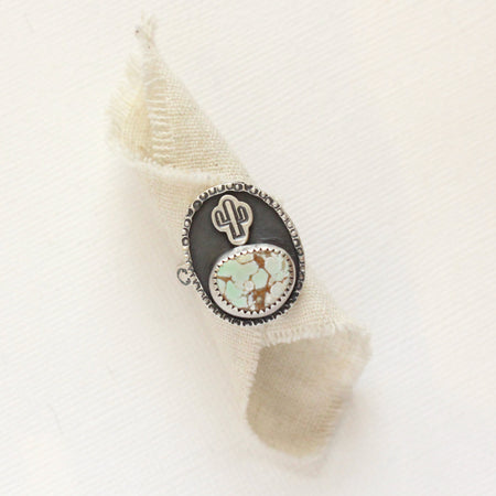 The little cactus turquoise ring styled on rolled linen