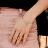The turquoise heart bangle bracelet being worn on a wrist