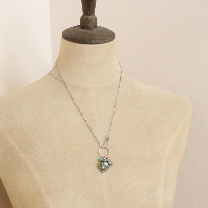 A mannequin wearing the royston turquoise heart charm necklace