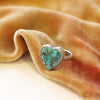 The turquoise heart ring styled on yellow velvet