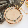The serenity soar bracelet styled on wood with gray velvet and dried grass