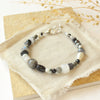 The dark side of the moon bracelet styled on a tan rock