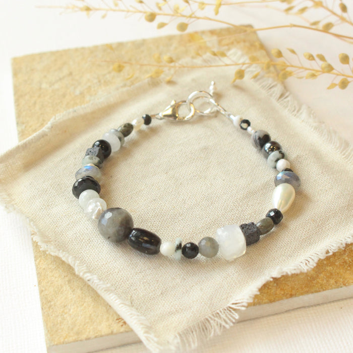 The dark side of the moon bracelet styled on a tan rock