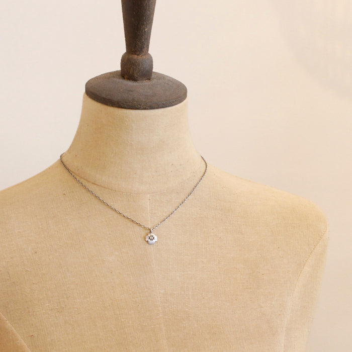 A mannequin wearing the zuni cross necklace